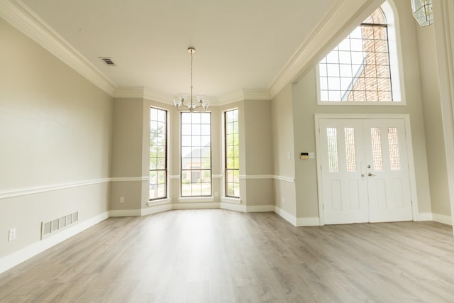 2302 Tiffany Ct, Garland, TX 75043 - entrance foyer with a chandelier, ornamental molding, plenty of natural light, light wood-style floors, and baseboards