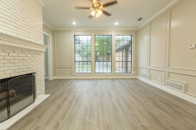 2302 Tiffany Ct, Garland, TX 75043 - unfurnished living room with a decorative wall, ornamental molding, ceiling fan, a fireplace, and wood finished floors