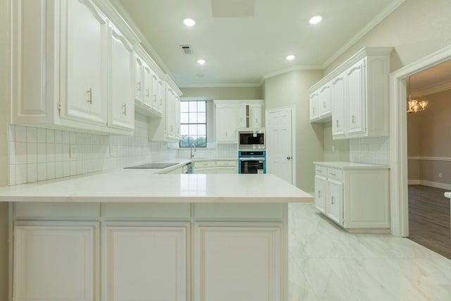 2302 Tiffany Ct, Garland, TX 75043 - kitchen featuring stainless steel appliances, a peninsula, decorative backsplash, crown molding, and a chandelier
