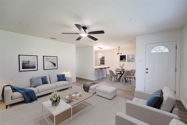 1620 E King St, Sherman, TX 75090 - living room with ceiling fan, light wood-style flooring, baseboards, and a chandelier