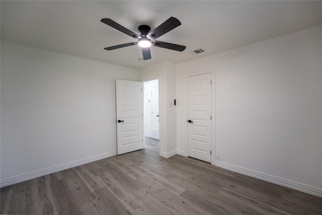 1620 E King St, Sherman, TX 75090 - unfurnished bedroom featuring wood finished floors, baseboards, and ceiling fan