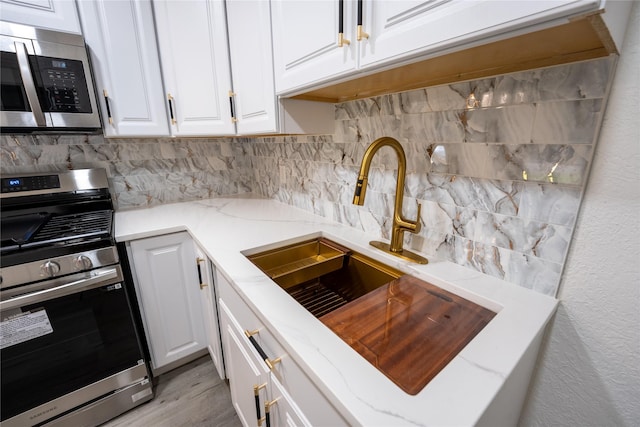 1620 E King St, Sherman, TX 75090 - kitchen with appliances with stainless steel finishes, a sink, tasteful backsplash, white cabinetry, and a textured wall