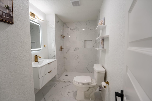 1620 E King St, Sherman, TX 75090 - bathroom with toilet, vanity, marble look tiles, a marble finish shower, and a textured wall