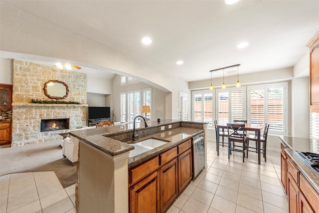 15534 Fox Meadow Ln, Frisco, TX 75035 - kitchen with a sink, appliances with stainless steel finishes, a fireplace, plenty of natural light, and recessed lighting