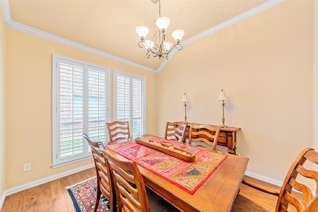 15534 Fox Meadow Ln, Frisco, TX 75035 - dining area featuring a chandelier, ornamental molding, baseboards, vaulted ceiling, and wood finished floors