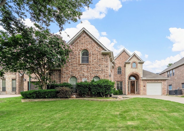 15534 Fox Meadow Ln, Frisco, TX 75035 - view of front of house with brick siding, a front yard, concrete driveway, and central AC unit