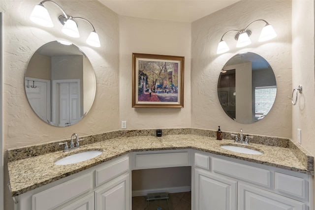 15534 Fox Meadow Ln, Frisco, TX 75035 - bathroom with double vanity, a textured wall, and tile patterned flooring