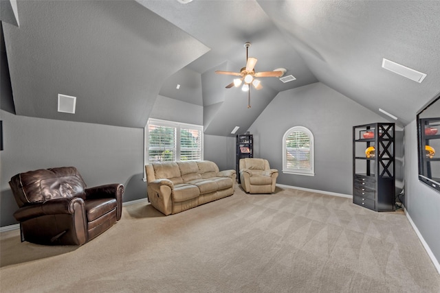 15534 Fox Meadow Ln, Frisco, TX 75035 - living room featuring light carpet, lofted ceiling, baseboards, ceiling fan, and a textured ceiling