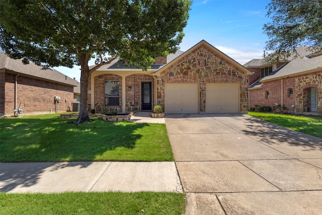 7008 Clipper Dr, Grand Prairie, TX 75054 - view of front facade with a garage, a front lawn, concrete driveway, stone siding, and central AC