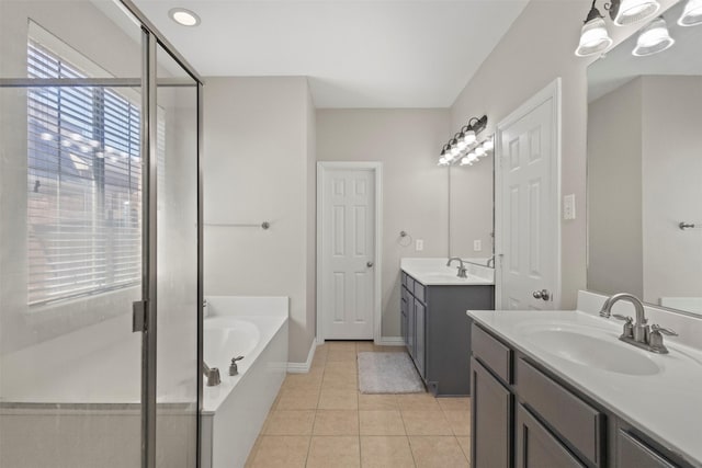 7008 Clipper Dr, Grand Prairie, TX 75054 - full bathroom featuring two vanities, a garden tub, a stall shower, and tile patterned flooring