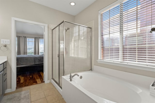 7008 Clipper Dr, Grand Prairie, TX 75054 - ensuite bathroom featuring a bath, a stall shower, tile patterned flooring, vanity, and recessed lighting