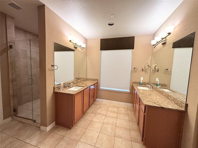2016 Azure Pointe, Richardson, TX 75080 - bathroom featuring a stall shower, tile patterned flooring, and two vanities