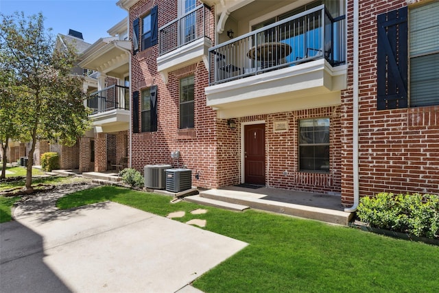 2016 Azure Pointe, Richardson, TX 75080 - entrance to property featuring brick siding, central air condition unit, and a yard