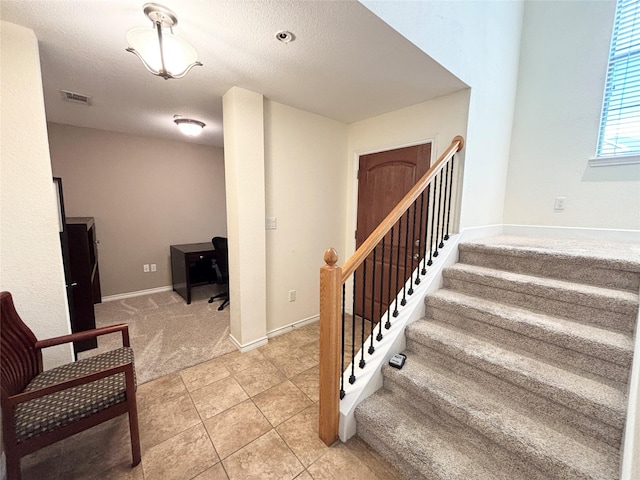2016 Azure Pointe, Richardson, TX 75080 - staircase featuring tile patterned floors, carpet, a textured ceiling, and baseboards