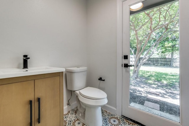 928 Westbrook Dr, Plano, TX 75075 - bathroom with toilet, baseboards, vanity, and healthy amount of natural light