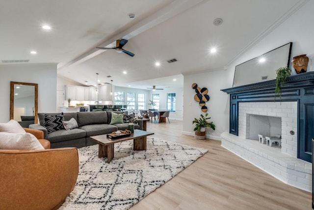 928 Westbrook Dr, Plano, TX 75075 - living room featuring ceiling fan, light wood finished floors, a brick fireplace, ornamental molding, and recessed lighting