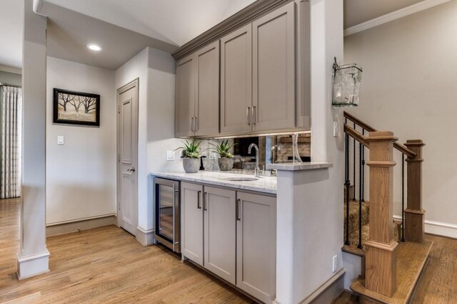2709 Redding Dr, Plano, TX 75093 - indoor wet bar with wine cooler, light wood-style floors, baseboards, recessed lighting, and crown molding