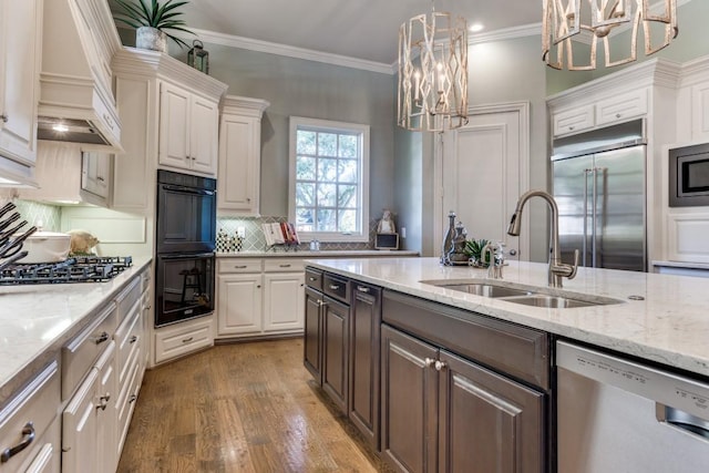 2709 Redding Dr, Plano, TX 75093 - kitchen with built in appliances, a chandelier, a sink, premium range hood, and white cabinetry