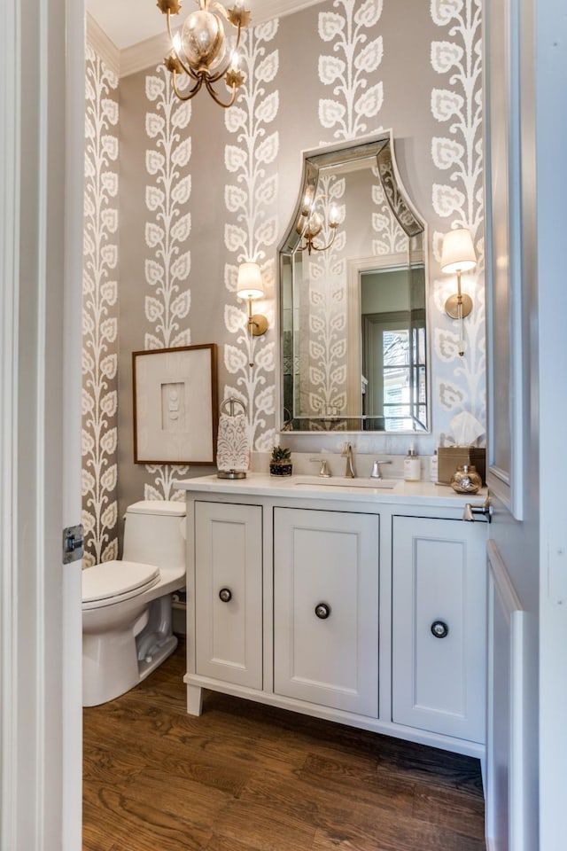 2709 Redding Dr, Plano, TX 75093 - half bathroom with crown molding, toilet, wallpapered walls, vanity, and a chandelier