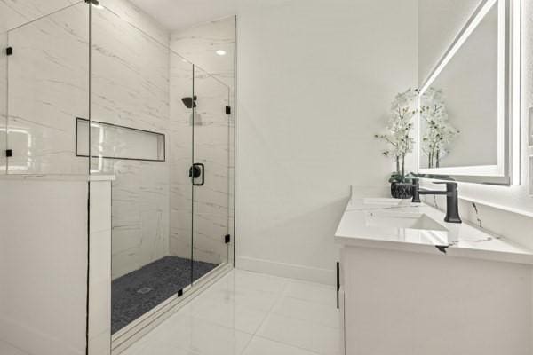 301 Bay Ct, Gun Barrel City, TX 75156 - full bath featuring a marble finish shower, double vanity, marble finish flooring, and baseboards