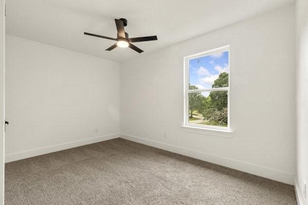 301 Bay Ct, Gun Barrel City, TX 75156 - unfurnished room featuring carpet, a ceiling fan, and baseboards