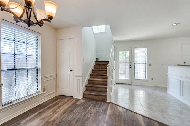 3631 Hilltop Ln, Plano, TX 75023 - entryway featuring stairway, a chandelier, wood finished floors, and a wainscoted wall