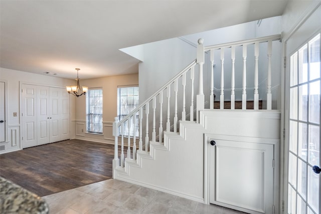 3631 Hilltop Ln, Plano, TX 75023 - stairway with a chandelier and tile patterned flooring