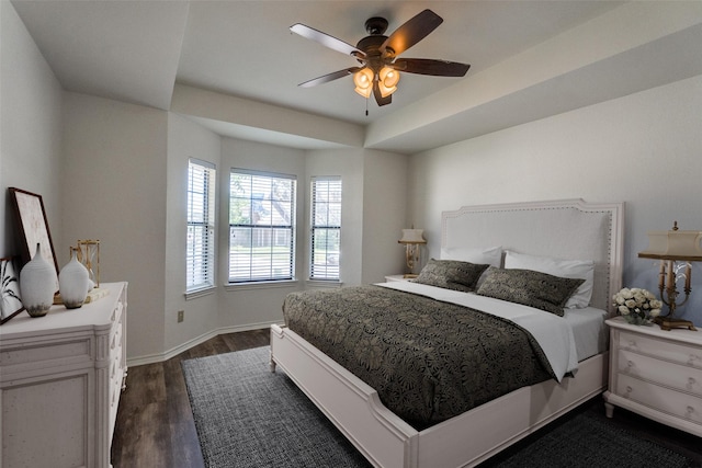 3631 Hilltop Ln, Plano, TX 75023 - bedroom featuring dark wood-style floors, baseboards, ceiling fan, and a raised ceiling