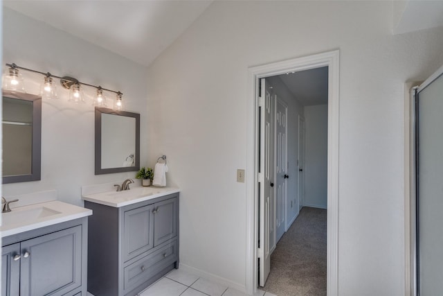 3631 Hilltop Ln, Plano, TX 75023 - bathroom with two vanities, tile patterned flooring, lofted ceiling, baseboards, and a shower with door