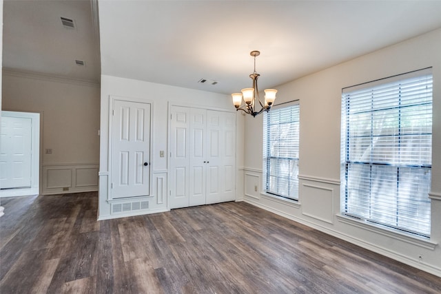 3631 Hilltop Ln, Plano, TX 75023 - unfurnished dining area featuring a decorative wall, a chandelier, dark wood-style floors, and a wainscoted wall