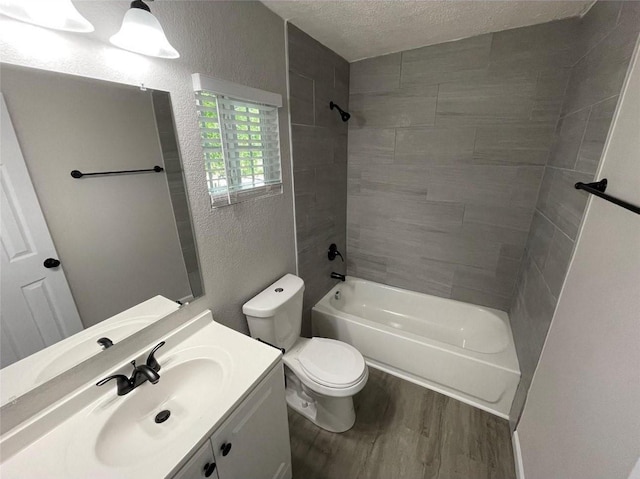 2722 Hector St, Dallas, TX 75210 - bathroom with wood finished floors, a textured wall, a textured ceiling, toilet, and bathtub / shower combination