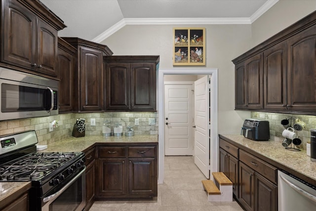 365 Maggie Cir, Flint, TX 75762 - kitchen with stainless steel appliances, backsplash, dark brown cabinetry, lofted ceiling, and ornamental molding