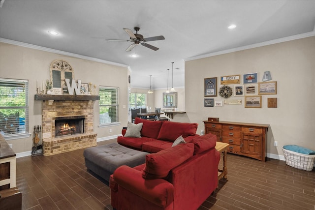 365 Maggie Cir, Flint, TX 75762 - living room featuring baseboards, wood finish floors, a warm lit fireplace, crown molding, and a ceiling fan