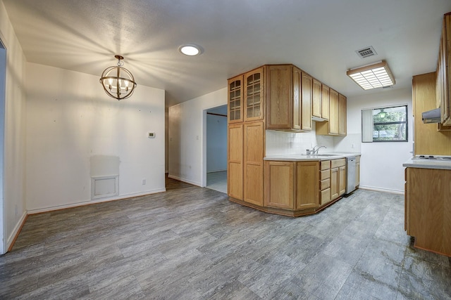 2947 Sinbad Cir, Farmers Branch, TX 75234 - kitchen featuring under cabinet range hood, light countertops, a chandelier, and glass insert cabinets