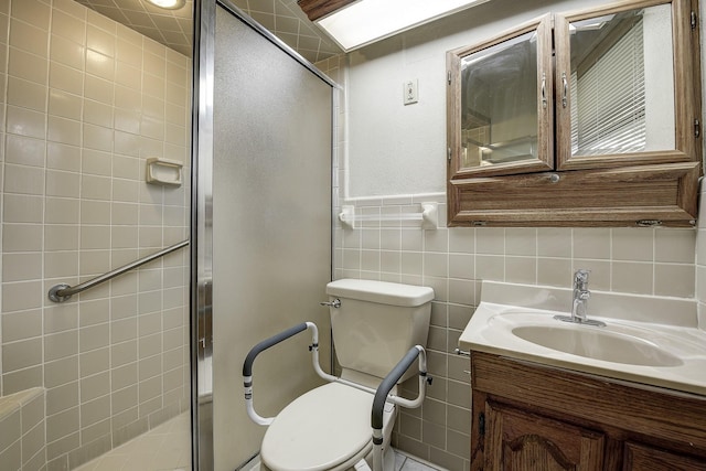 2947 Sinbad Cir, Farmers Branch, TX 75234 - full bathroom with toilet, a shower stall, vanity, tile walls, and wainscoting