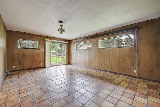 2947 Sinbad Cir, Farmers Branch, TX 75234 - spare room featuring baseboards and wood walls