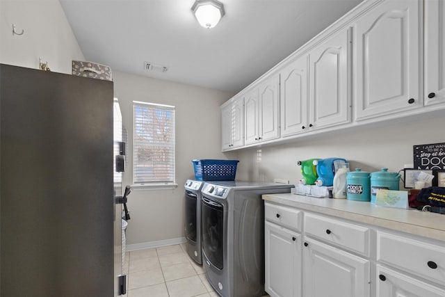 301 Northcreek Dr, Chandler, TX 75758 - laundry area with washing machine and dryer, cabinet space, baseboards, and light tile patterned floors