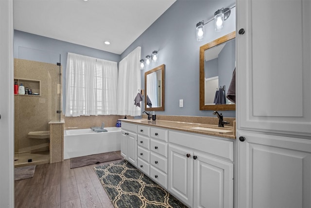 301 Northcreek Dr, Chandler, TX 75758 - full bath featuring a garden tub, a stall shower, double vanity, and wood finished floors