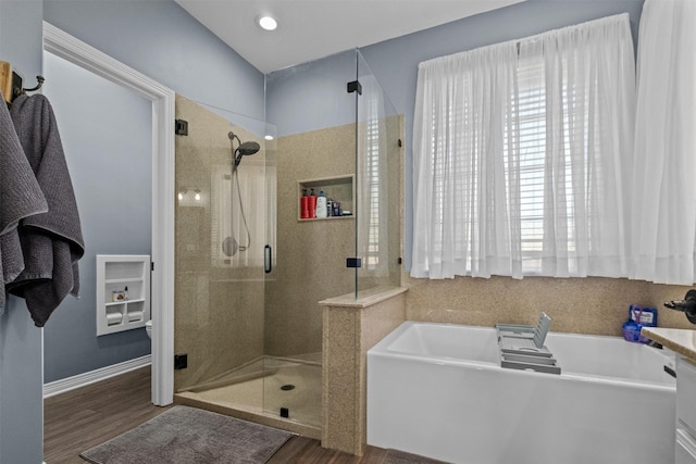 301 Northcreek Dr, Chandler, TX 75758 - full bathroom with a shower stall, wood finished floors, a bath, and baseboards