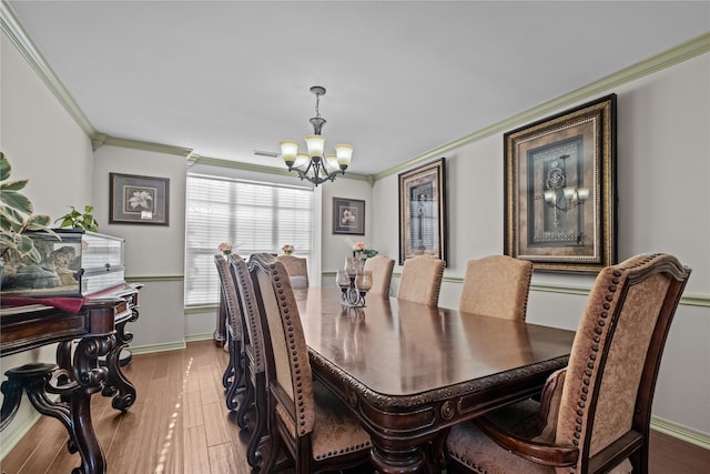 301 Northcreek Dr, Chandler, TX 75758 - dining area featuring a chandelier, ornamental molding, baseboards, and wood finished floors