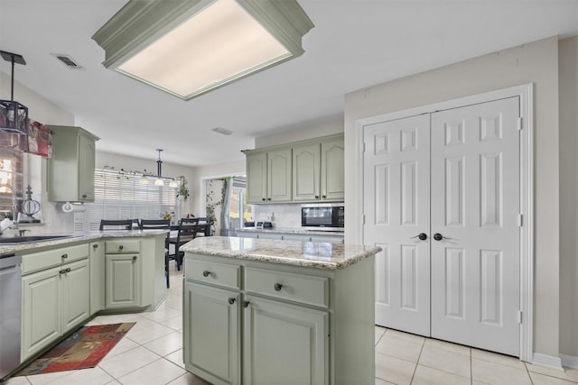 301 Northcreek Dr, Chandler, TX 75758 - kitchen with green cabinets, stainless steel appliances, light tile patterned floors, tasteful backsplash, and decorative light fixtures