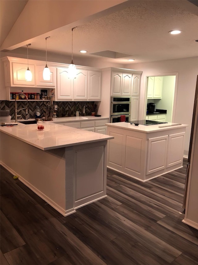 148 Vista Dr, Eustace, TX 75124 - kitchen with white cabinets, recessed lighting, a kitchen island, dark wood-style floors, and decorative backsplash