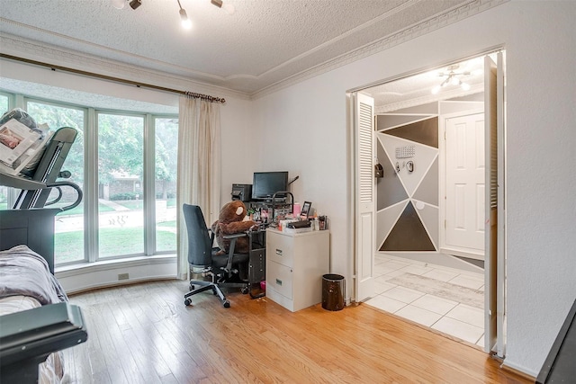 217 NE Rosamond St, Burleson, TX 76028 - office area featuring ornamental molding, healthy amount of natural light, a textured ceiling, and wood finished floors