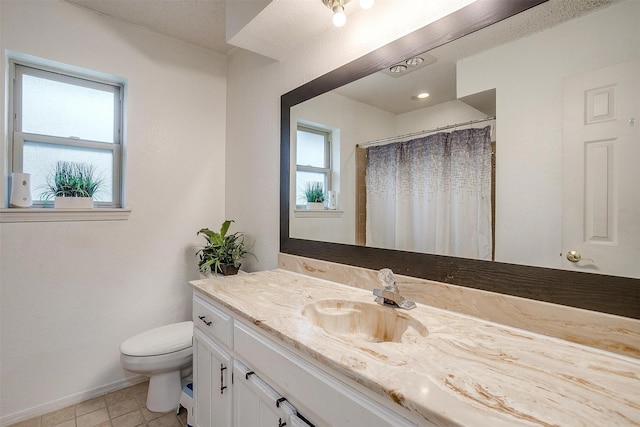 217 NE Rosamond St, Burleson, TX 76028 - bathroom with toilet, vanity, baseboards, tile patterned floors, and a shower with curtain