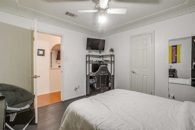217 NE Rosamond St, Burleson, TX 76028 - bedroom featuring arched walkways, dark wood-style flooring, crown molding, and a ceiling fan