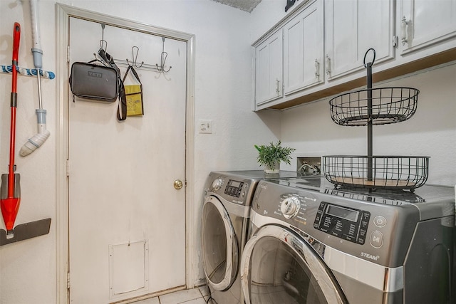 217 NE Rosamond St, Burleson, TX 76028 - laundry room with washing machine and clothes dryer, cabinet space, and light tile patterned floors