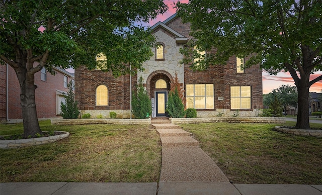1496 Hazel Green Dr, Frisco, TX 75033 - view of front of house featuring a front yard, stone siding, and brick siding