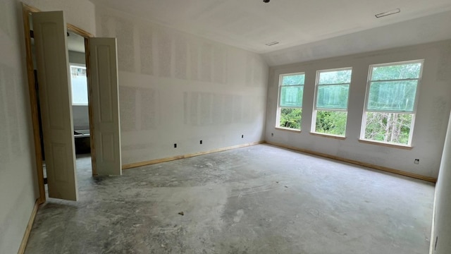4089 Vista Oak Ct, Royse City, TX 75189 - empty room with concrete flooring, lofted ceiling, and baseboards