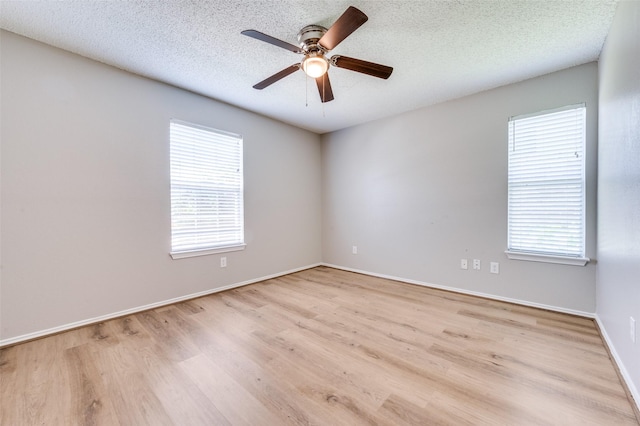 2521 Markland St, Irving, TX 75060 - unfurnished room featuring ceiling fan, wood finished floors, healthy amount of natural light, baseboards, and a textured ceiling