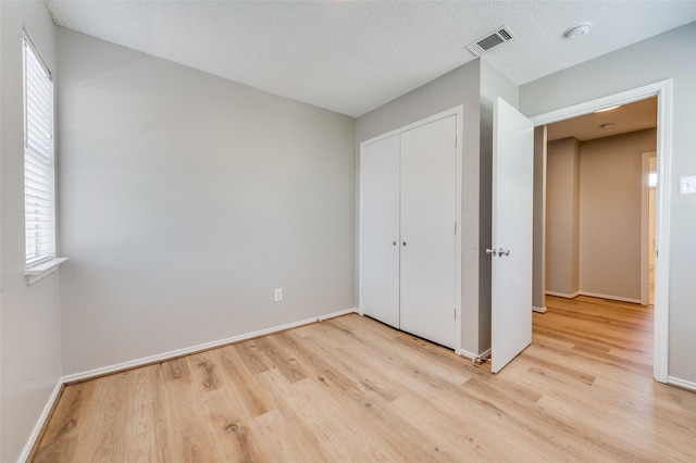 2521 Markland St, Irving, TX 75060 - unfurnished bedroom featuring wood finished floors, baseboards, and a closet